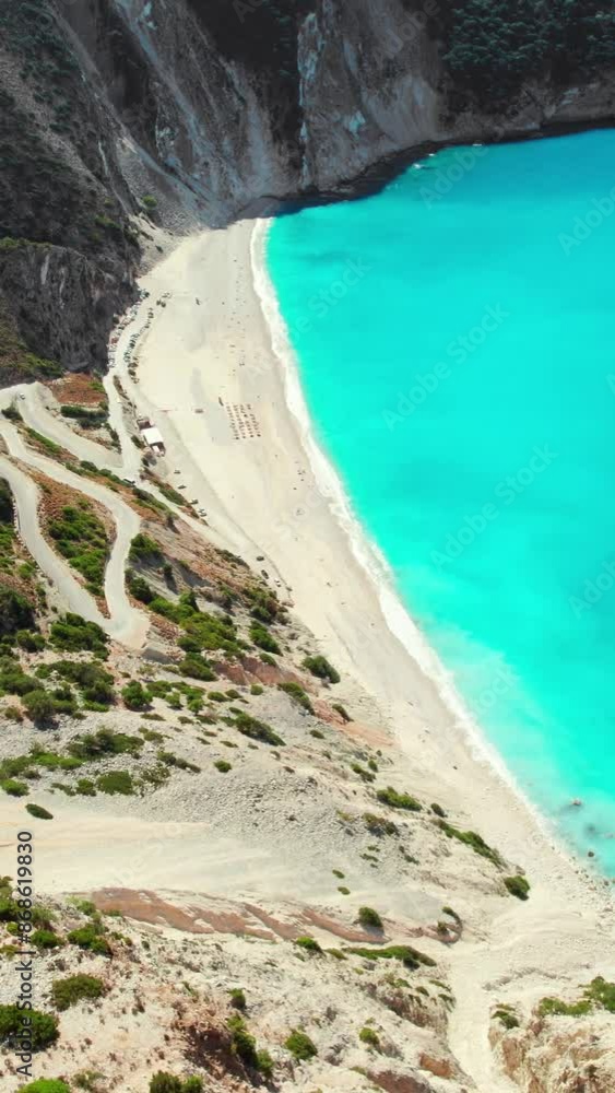 Aerial view of Myrtos beach on summer day on Kefalonia island, Ionian sea, Greece. Slow revealing drone footage. Idyllic white sandy beach on the shores of a beautiful turquoise sea. Aerial view of Myrtos beach on summer day on Kefalonia island, Ionian sea, Greece. Slow revealing drone footage. Idyllic white sandy beach on the shores of a beautiful turquoise sea.
