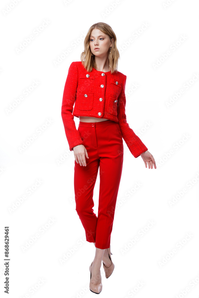 High fashion photo of a beautiful elegant young woman in pretty red pants, trousers, jacket posing on white background. Slim figure. Blonde High fashion photo of a beautiful elegant young woman in pretty red pants, trousers, jacket posing on white background. Slim figure. Blonde