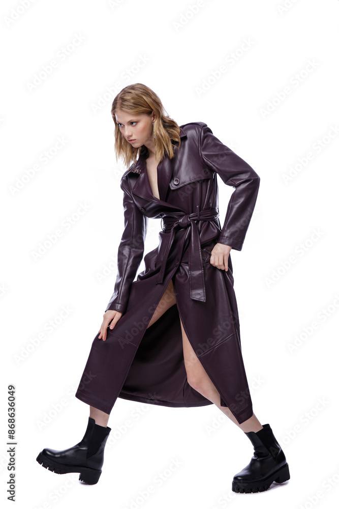 High fashion photo of a beautiful elegant young woman in pretty long purple lilac leather jacket, coat posing on white background. Slim figure. Blonde High fashion photo of a beautiful elegant young woman in pretty long purple lilac leather jacket, coat posing on white background. Slim figure. Blonde