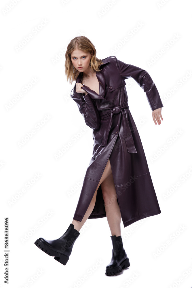 High fashion photo of a beautiful elegant young woman in pretty long purple lilac leather jacket, coat posing on white background. Slim figure. Blonde High fashion photo of a beautiful elegant young woman in pretty long purple lilac leather jacket, coat posing on white background. Slim figure. Blonde