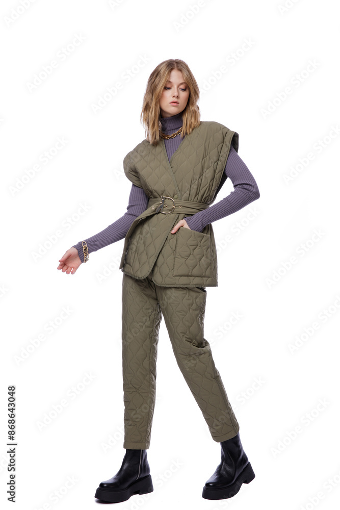 High fashion photo of a beautiful elegant young woman in pretty green pants, trousers, purple blouse, jacket posing on white background. Slim figure. Blonde High fashion photo of a beautiful elegant young woman in pretty green pants, trousers, purple blouse, jacket posing on white background. Slim figure. Blonde