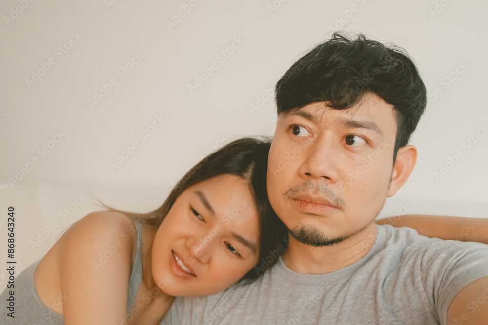 Fototapeta premium Selfie shot of asian sweet couple lover watching movie together in the room