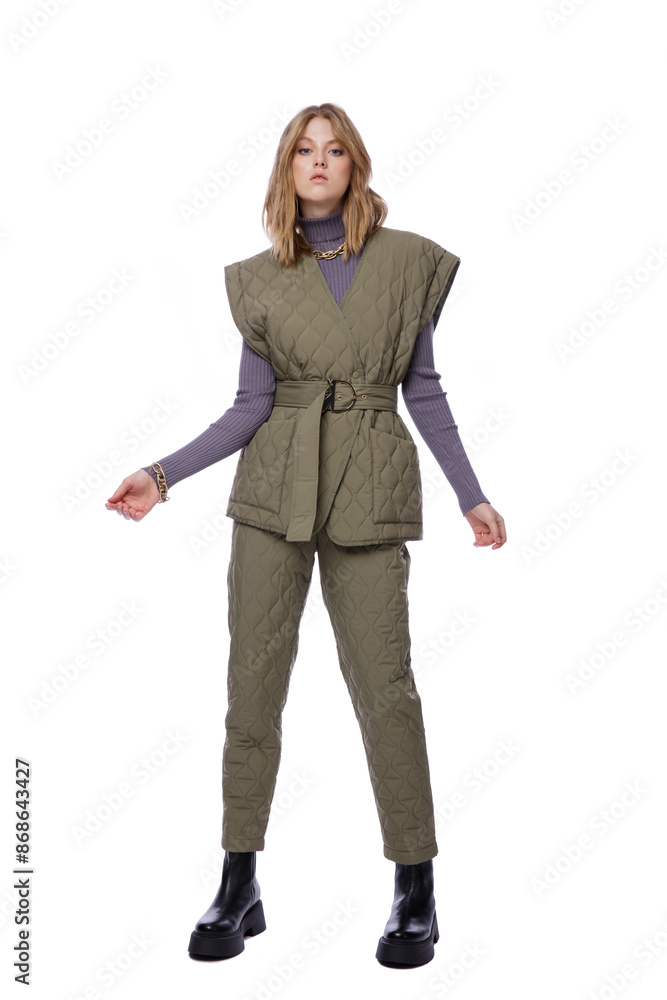 Fototapeta premium High fashion photo of a beautiful elegant young woman in pretty green pants, trousers, purple blouse, jacket posing on white background. Slim figure. Blonde