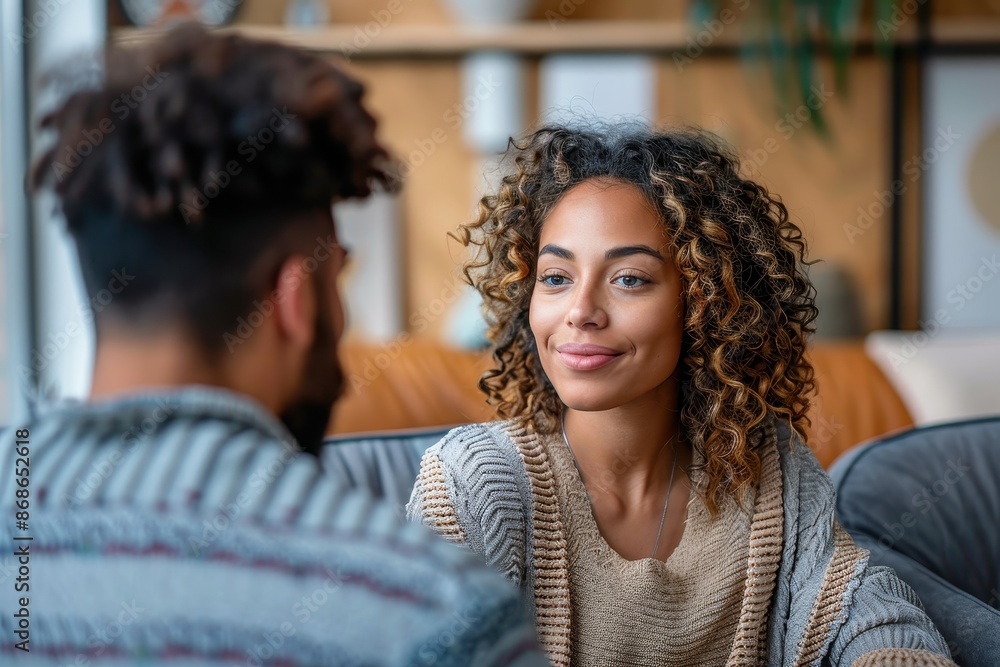 Two friends having a casual conversation, smiling and engaging warmly, showcasing friendship and connection against a cozy, stylish interior background with plants and cushions. Two friends having a casual conversation, smiling and engaging warmly, showcasing friendship and connection against a cozy, stylish interior background with plants and cushions.