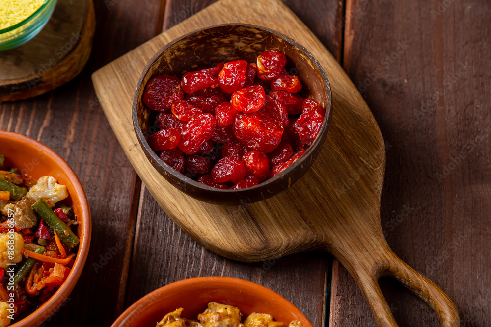 Dogwood in a wooden plate on a board on the table Dogwood in a wooden plate on a board on the table