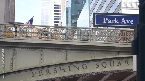 New York City Grand Central Terminal, 42 street, Park Avenue, Pershing Square bridge architecture. Midtown district railroad hub, railway transport. American flag, NY crossroad, intersection road sign