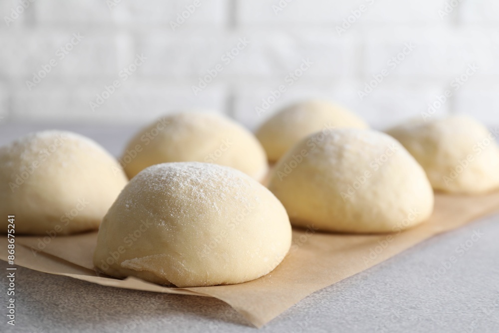 Raw dough balls on light grey table, closeup Raw dough balls on light grey table, closeup