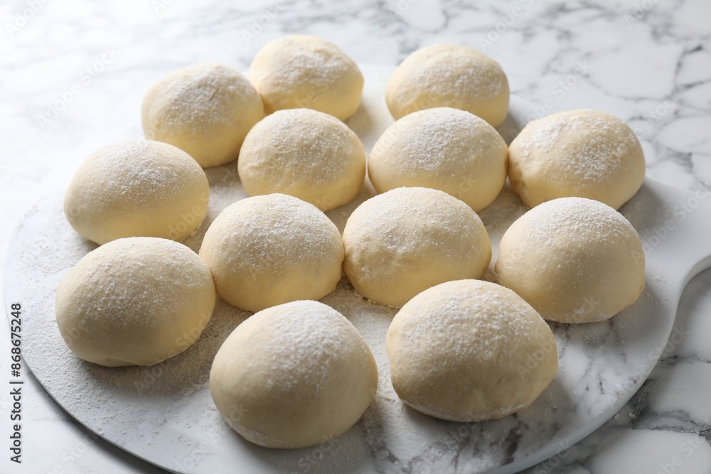 Raw dough balls on white marble table Raw dough balls on white marble table