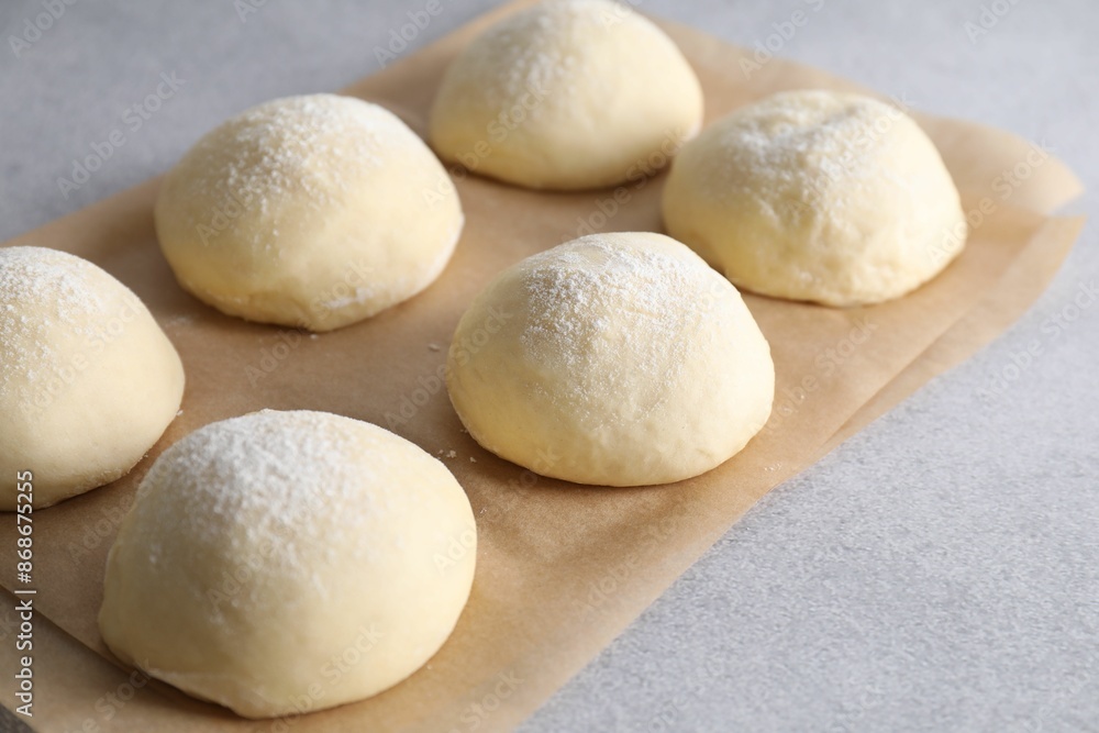 Raw dough balls on light grey table Raw dough balls on light grey table