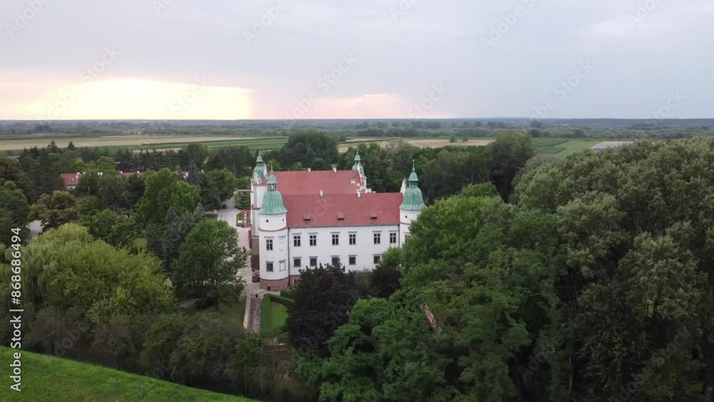European castle in the evening in the middle of trees European castle in the evening in the middle of trees