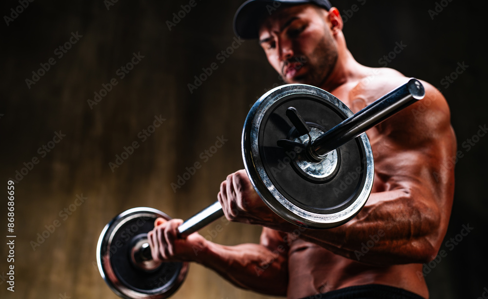 Naklejka premium Strong man bodybuilder training with barbell, focus on barbell