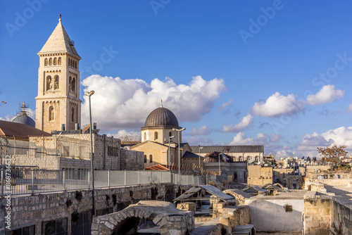 The rooftops of Jerusalem Old City, with the tower of Lutheran Church of the Redeemer, other Christian cathedrals, Catholic and Orthodox churches, and old walls, in Israel.  photo