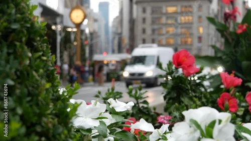 New York City, United States, Manhattan Midtown Broadway, 23 street, 5 avenue crossroad intersection. Worth Square near Madison Park, Flatiron, USA. Yellow taxi cab, flowers, street clock, school bus.