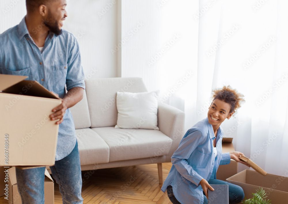 Moving Concept. Joyful African American Spouses Packing Stuff In Boxes Indoor Preparing For Relocation. Selective Focus Moving Concept. Joyful African American Spouses Packing Stuff In Boxes Indoor Preparing For Relocation. Selective Focus