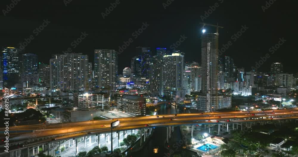 Above view of wide highway crossroads in Miami city, Florida at night with fast driving cars. USA transportation infrastructure concept Above view of wide highway crossroads in Miami city, Florida at night with fast driving cars. USA transportation infrastructure concept