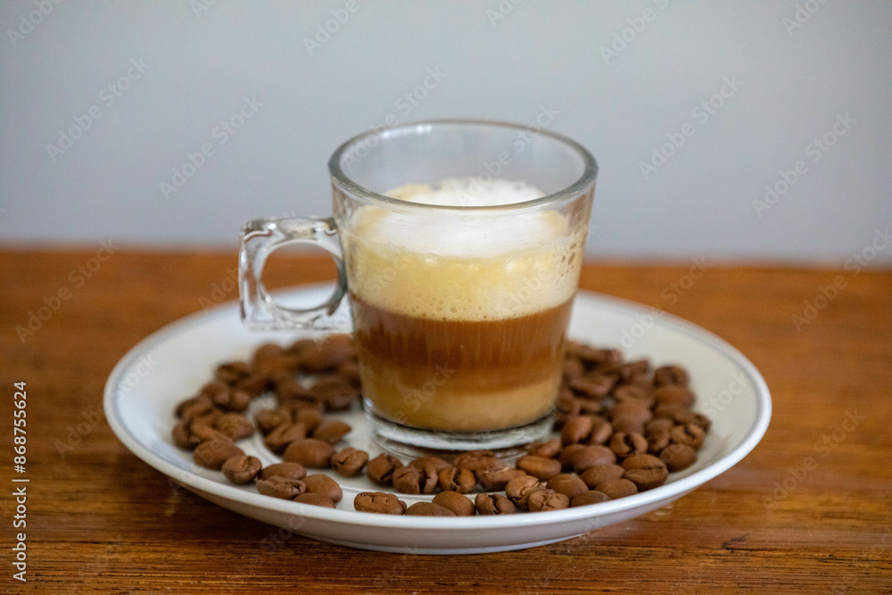 Espresso coffee served in a transparent cup with roasted coffee beans. Gourmet, 100% Arabica special
