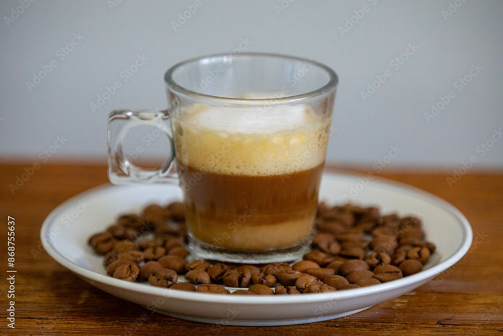 Espresso coffee served in a transparent cup with roasted coffee beans. Gourmet, 100% Arabica special Espresso coffee served in a transparent cup with roasted coffee beans. Gourmet, 100% Arabica special