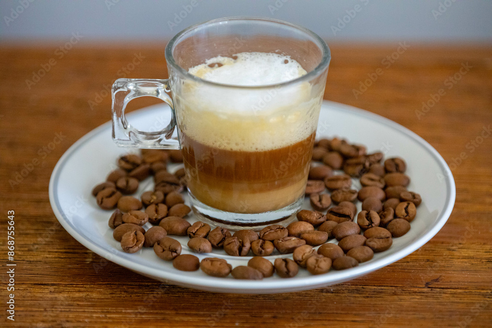 Espresso coffee served in a transparent cup with roasted coffee beans. Gourmet, 100% Arabica special Espresso coffee served in a transparent cup with roasted coffee beans. Gourmet, 100% Arabica special