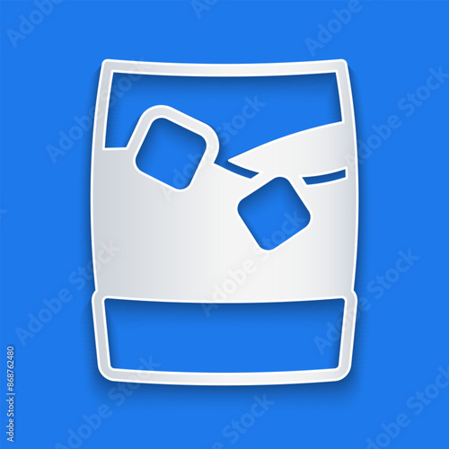 Paper cut Glass of whiskey with ice cubes icon isolated on blue background. Paper art style. Vector