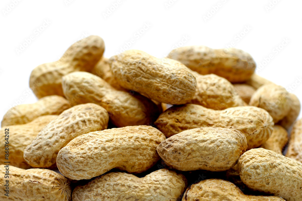 Roasted peanuts in shell on white background. Roasted peanuts in shell on white background.