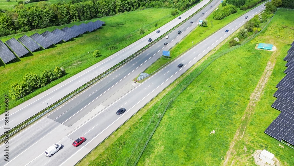 Drone view of the German motorway a7 with some cars and traffic in a green landscape. Drone view of the German motorway a7 with some cars and traffic in a green landscape.