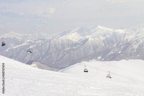 The peaks of snowy Caucasus mountains in The Gudauri Ski Resort, Georgia. Snowboarding in The Gudauri Ski Resort, Georgia