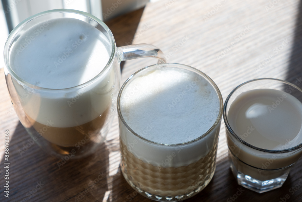 Sparkling latte in glass crystal glass on wooden table Sparkling latte in glass crystal glass on wooden table