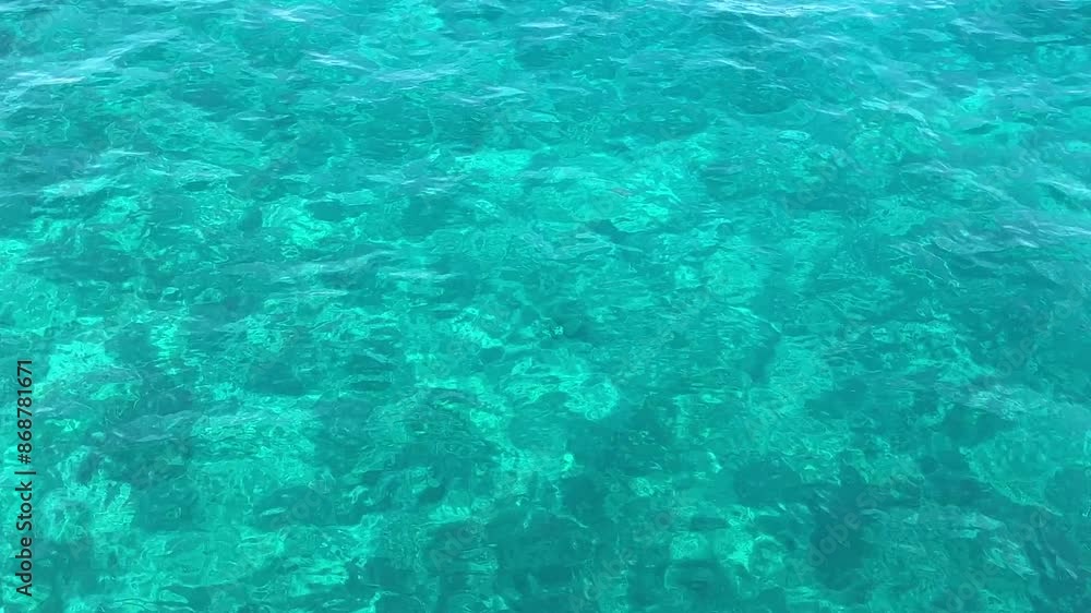 Transparent water of the Adriatic Sea, close-up. Reflection of the sun in clear turquoise sea water. Transparent water of the Adriatic Sea, close-up. Reflection of the sun in clear turquoise sea water.