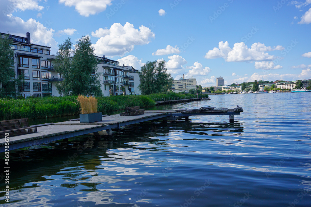 Fototapeta premium Scenic view of river by buildings against sky