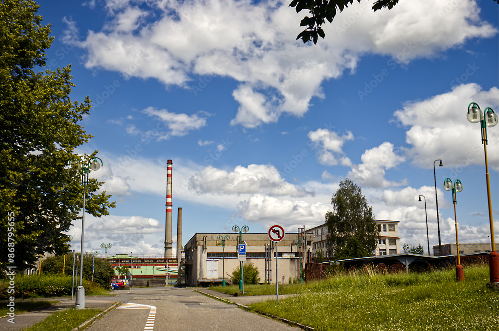 Urban scene with a park and a factory in the background. Factory close to urban development with a park. Park, nature and factory. Urban environment, environment Urban scene with a park and a factory in the background. Factory close to urban development with a park. Park, nature and factory. Urban environment, environment