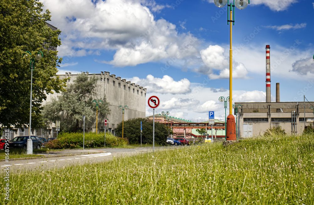 Urban scene with a park and a factory in the background. Factory close to urban development with a park. Park, nature and factory. Urban environment, environment Urban scene with a park and a factory in the background. Factory close to urban development with a park. Park, nature and factory. Urban environment, environment