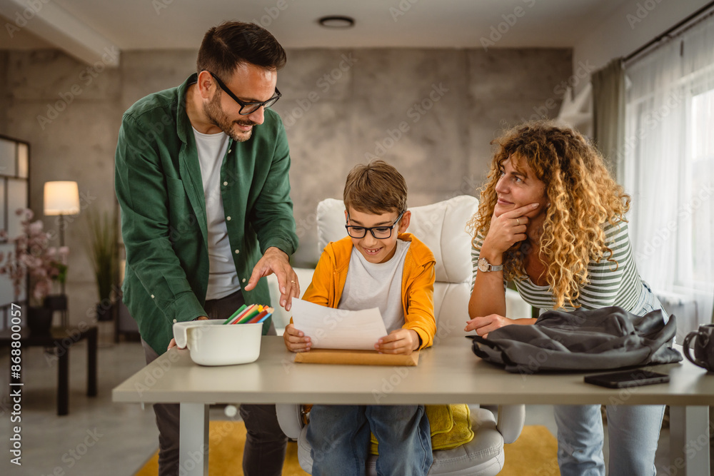 Mom and dad help son to do homework after school Mom and dad help son to do homework after school
