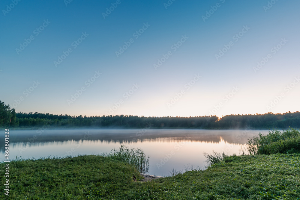 Small forest lake covered with fog at sunrise on June morning Small forest lake covered with fog at sunrise on June morning