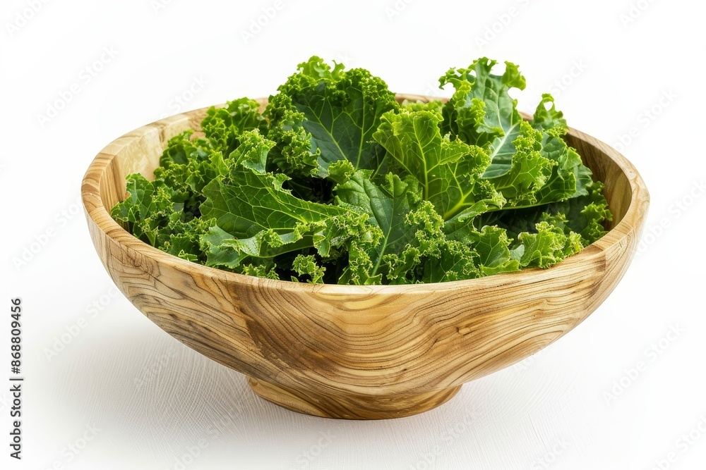 Vegan kale chips in wooden bowl on white background Emphasize clean eating Vegan kale chips in wooden bowl on white background Emphasize clean eating
