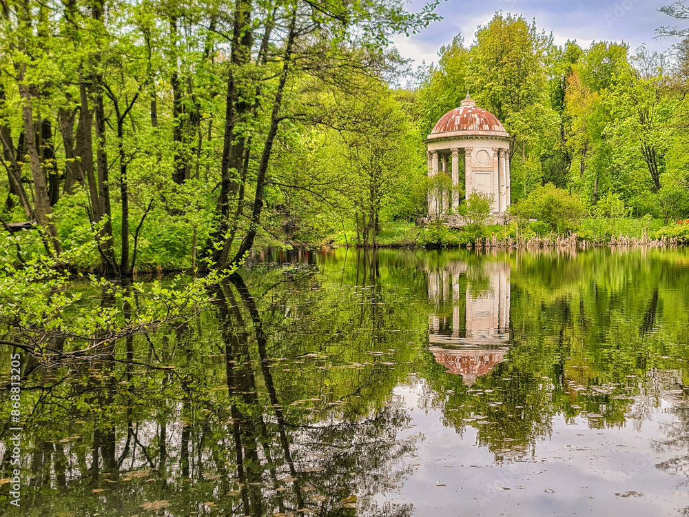 Small lake in autumn forest, reflection on water, under blue sky Small lake in autumn forest, reflection on water, under blue sky