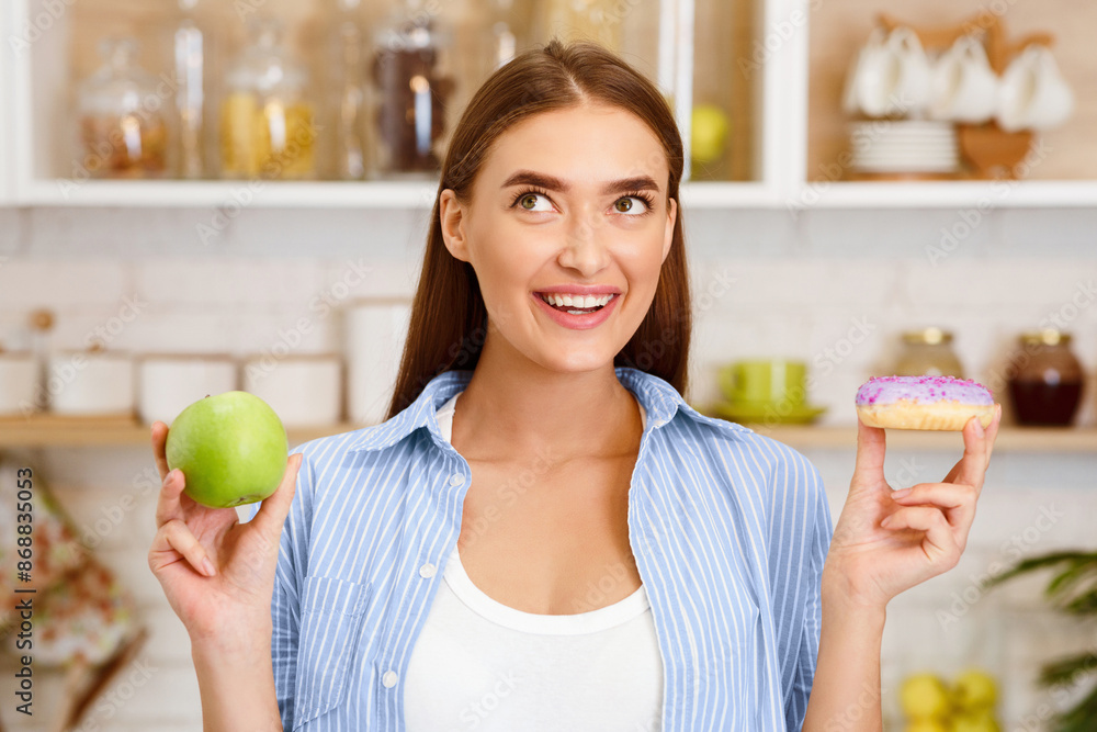 Diet. Beautiful Woman Choosing Between Fruits and Sweets In Kitchen Diet. Beautiful Woman Choosing Between Fruits and Sweets In Kitchen