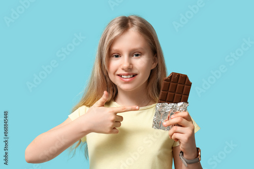 Cute little girl pointing a...