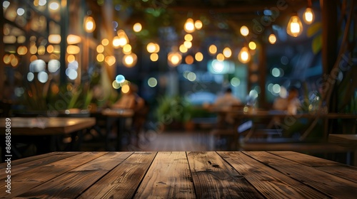 The empty wooden table top with blur background of restaurant at night