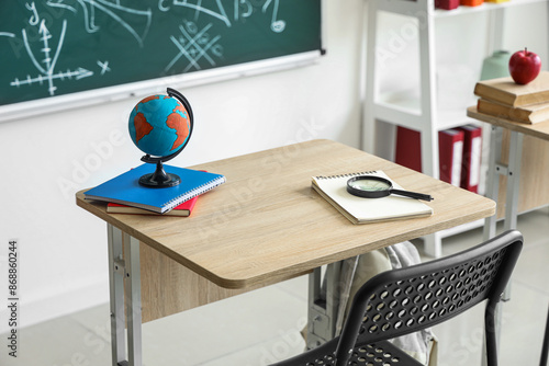 Globe with notebooks and ma...