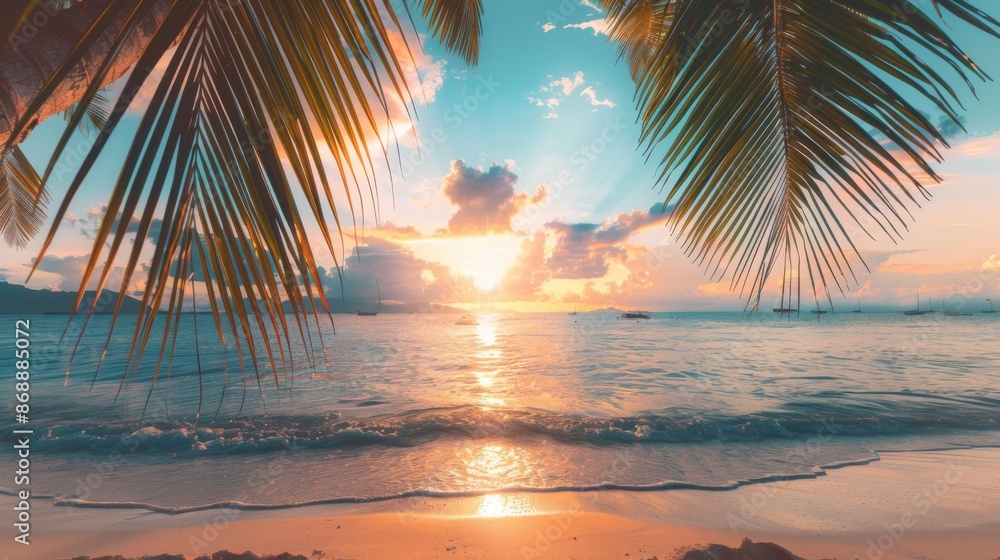 Fototapeta premium Sunset over a tranquil beach, viewed through palm leaves, illuminating the sky and water with a warm glow, creating a peaceful and serene scene.