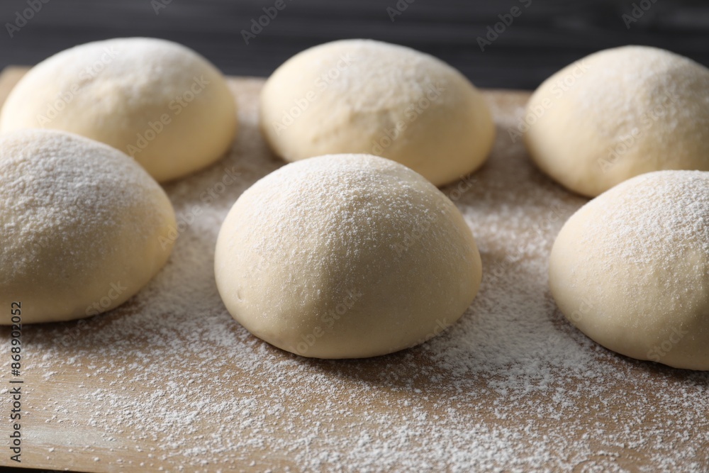 Raw dough balls with flour on table, closeup Raw dough balls with flour on table, closeup