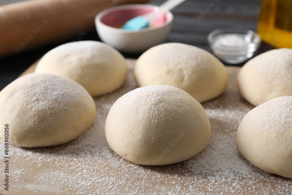 Raw dough balls and flour on table, closeup Raw dough balls and flour on table, closeup