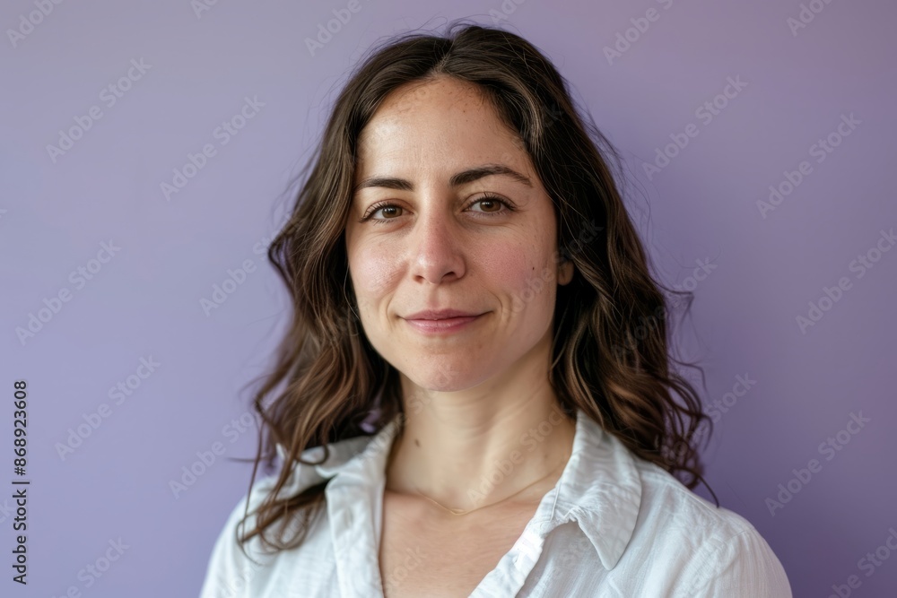 Portrait of a beautiful young woman with long brown hair on a purple background Portrait of a beautiful young woman with long brown hair on a purple background