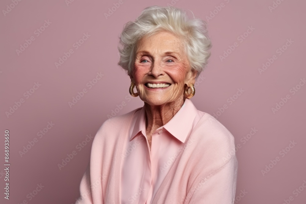 Portrait of a smiling senior woman on a pink background. Beauty, fashion. Portrait of a smiling senior woman on a pink background. Beauty, fashion.