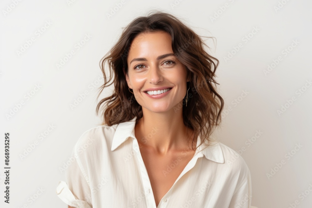 Portrait of a smiling young woman looking at camera over white background Portrait of a smiling young woman looking at camera over white background