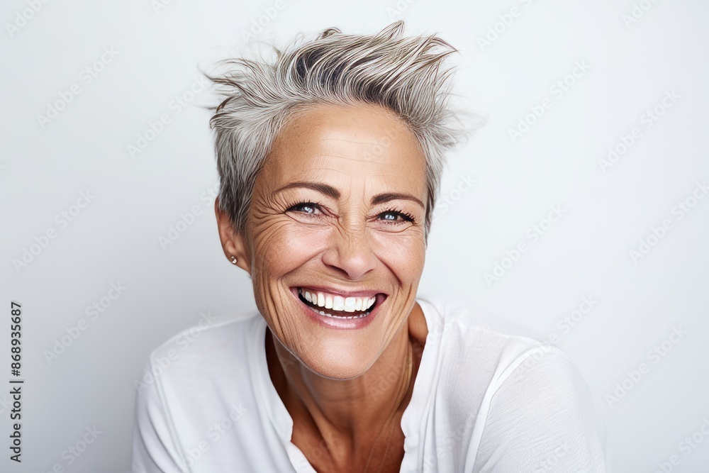 Portrait of a happy senior woman looking at the camera over grey background Portrait of a happy senior woman looking at the camera over grey background
