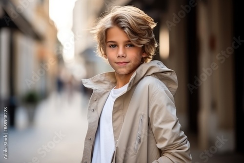 Portrait of a beautiful young woman with blond hair in the city