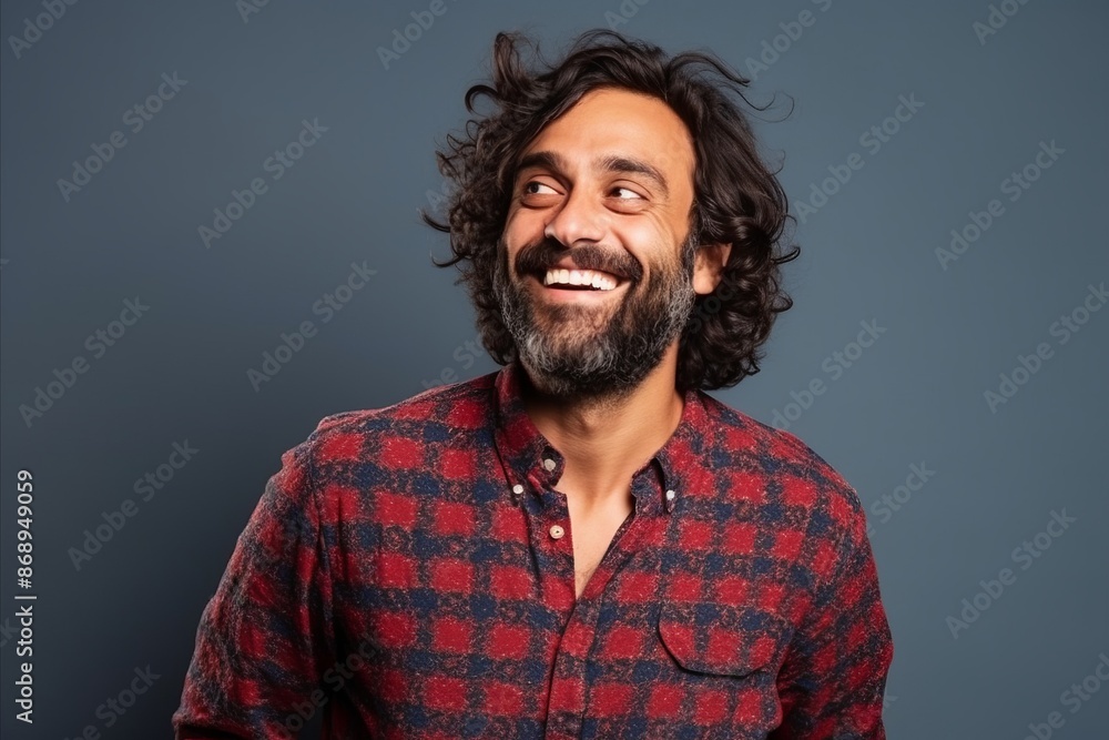 Portrait of a handsome man laughing and looking up over blue background Portrait of a handsome man laughing and looking up over blue background