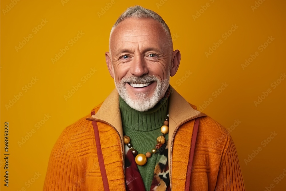 Portrait of smiling senior man in stylish clothes, on orange background Portrait of smiling senior man in stylish clothes, on orange background