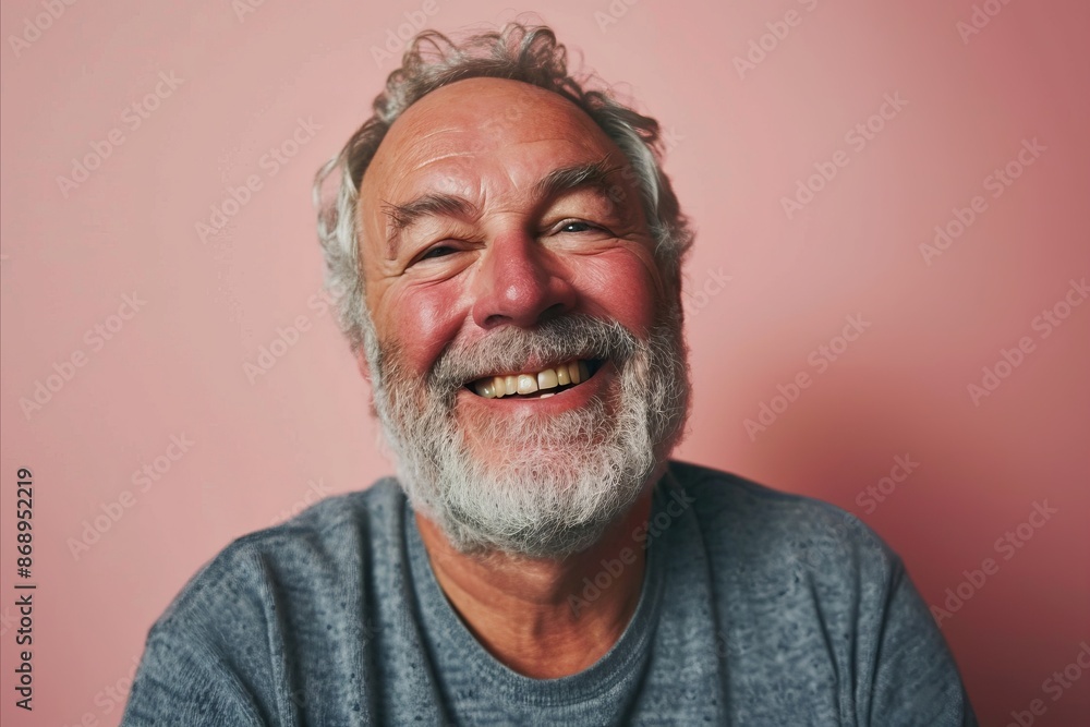 Senior man with white beard and mustache smiling happy on pink background.